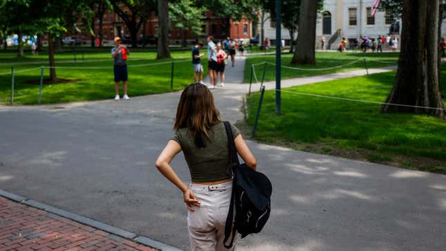 A Harvard University student walks through Harvard’s campus.