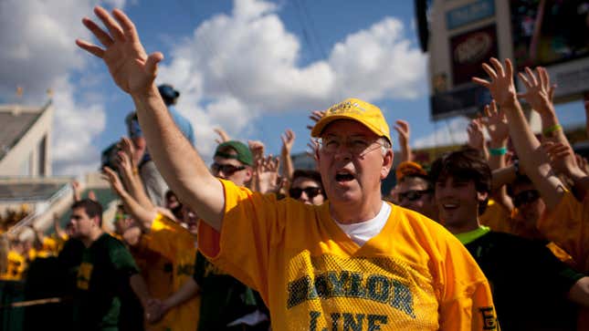 WACO, TX - NOVEMBER 3: Baylor University President Ken Starr cheers with students prior to kickoff against the University of Kansas Jayhawks on November 3, 2012 at Floyd Casey Stadium in Waco, Texas. (Photo by Cooper Neill/Getty Images)